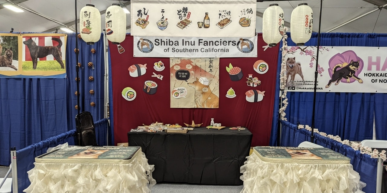 convention booth with images of Shibas and sushi
